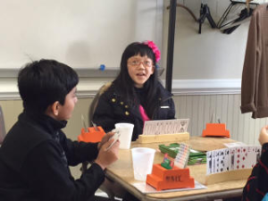 [Two students playing bridge around Halloween time.]